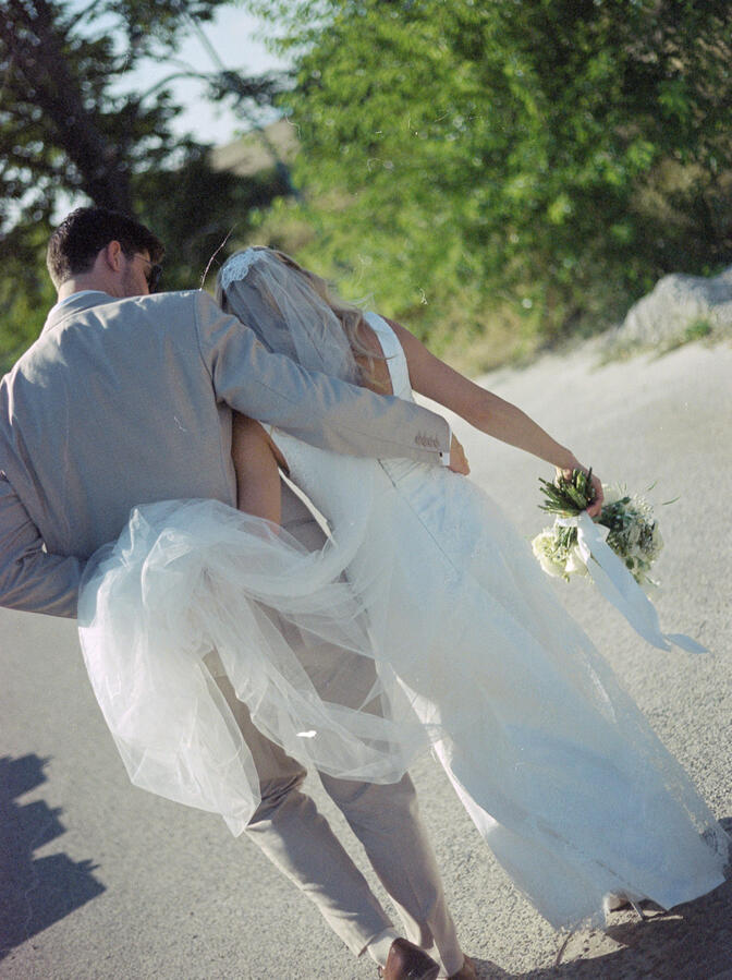 bride and groom walking and cuddling